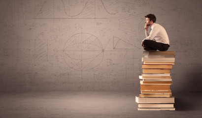Businessman sitting on books