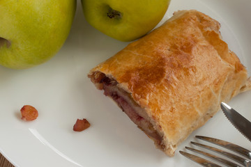 Homemade puff pie with apples, raisins and nuts