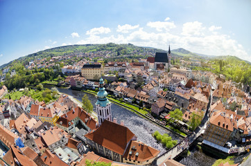 Fototapeta na wymiar Panoramic aerial view of historical center of Cesky Krumlov, Czech Republic. Spring or summer cityscape. Fisheye lens view of roofs of Cesky Krumlov.