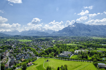 Panoramic aerial view of historical center and architecture of Salzburg, Austria. Beautiful view from Fortress Hohensalzburg. Austrian Alps in the background in springtime.