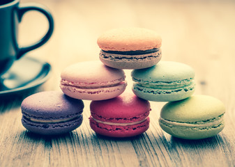 Colorful French Macarons on wooden background : vintage filtered