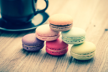 Colorful French Macarons on wooden background : vintage filtered
