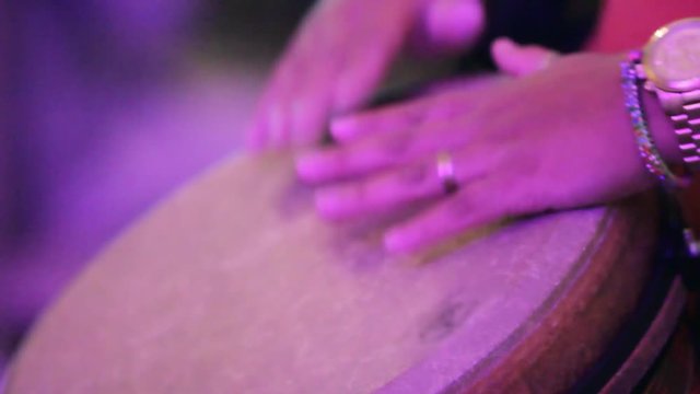 Close-up of hands playing conga