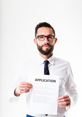 office worker with glasses showing an application form