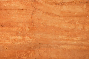 Rammed earth wall with different shades of orange soil - obrazy, fototapety, plakaty