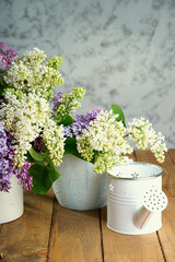 Purple and white lilac bunch with watering can 
