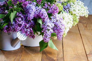 Purple and white lilac bunch with watering can 