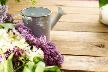 Purple and white lilac and watering can