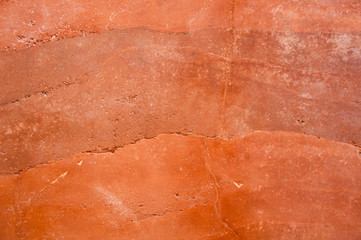 Rammed earth wall with different shades of orange soil - obrazy, fototapety, plakaty