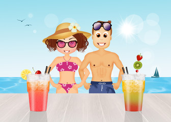 men and women drink cocktails at the beach