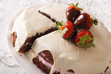 chocolate cake with white icing and strawberries close-up. Horizontal
