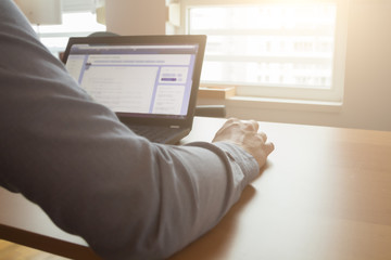 Working on a laptop. Shallow depth of field.