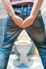 Man suffers from diarrhea in restroom.