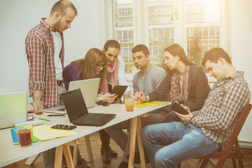 Young group of people discussing business plans.
