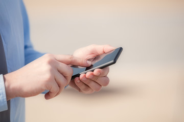 Texting on a smartphone. Shallow depth of field.