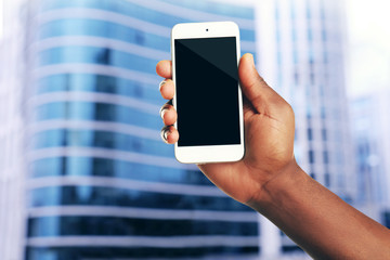 Mans hand shows mobile smart phone, blurred background