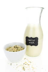 Hemp milk and hemp hearts in bowl,  on white background