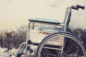 Vintage,Old Wheelchairs with wall background