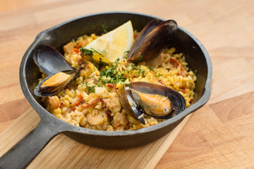 Paella with mussels on pan