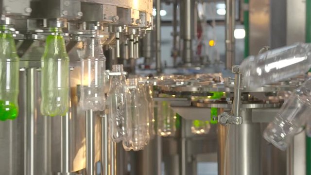 Bottling of lemonade in plastic bottles. Lemonade bottle conveyor industry