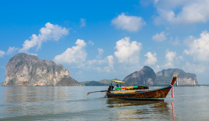 Beautiful Landscape of Pak Meng beach with long-tail wooden boat  and limestone mountain in Trang, Thailand