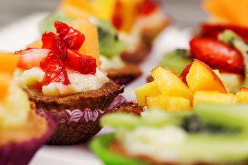close up of mini pastry with custard cream and fruits
