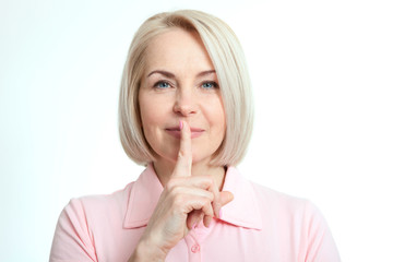 Naklejka premium Portrait woman with finger on lips, or secret gesture hand sign isolated on white background