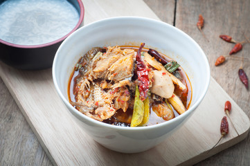 Sour and Spicy Smoked dried Fish Soup on and rice porridge wood