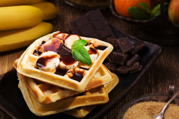 Delicious waffles with banana and chocolate