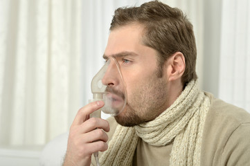 Man Inhaling Through Inhaler Mask