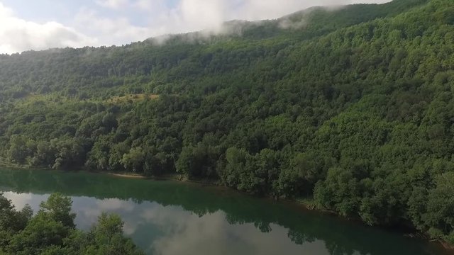 Flight over the river Drina Serbia. Aerial view of river Drina. Footage recorder from drone in full HD resolution.Aerial view of fields and meadows. Aerial view of the woods and the river