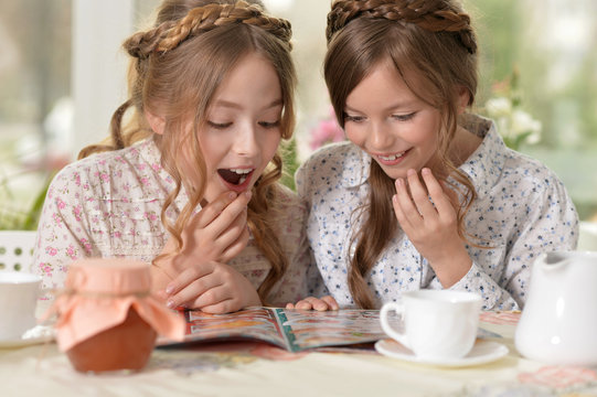 little girls reading a magazine 