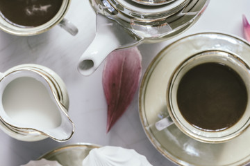 
Coffee service with marshmallows and peony petals