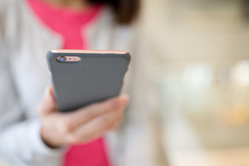 Woman surfing internet on cellphone