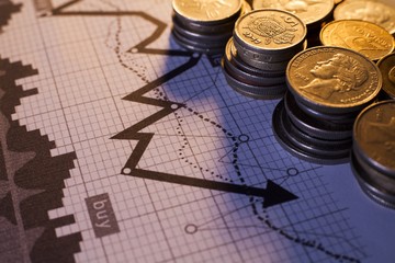 Stacks of varying heights of coins with chart