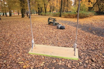 Park view with swings in the foreground 