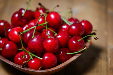 Fresh cherries in bowl on table