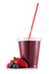 Smoothie in plastic cup with strawberry, bilberry and raspberry - obrazy, fototapety, plakaty
