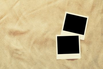 top view of blank instant photos album on sand background