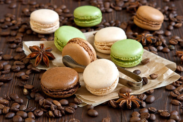 Delicious french macaroons on kraft paper on  wooden table