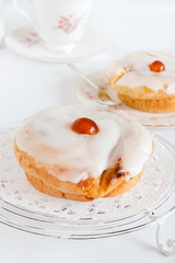 Belgian Buns a sweet sticky fruit bun covered in fondant icing
