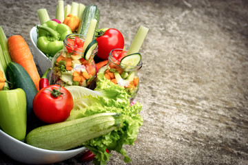 Fresh organic vegetables in jar and in bowl