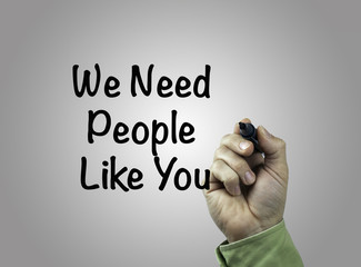 Hand with marker writing: We Need People Like You