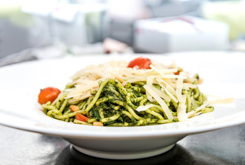 Pasta with pesto sauce and nuts on a the table