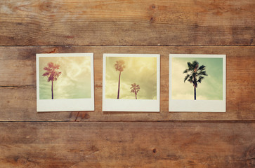 top view of instant photos album on wooden background