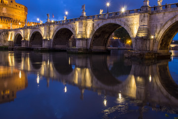 Fototapeta na wymiar Castel Sant Angelo bridge, reflecting onto the River Tiber at twilight, Rome, Italy, Europe