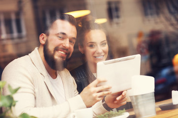 Fototapeta premium Happy couple using tablet