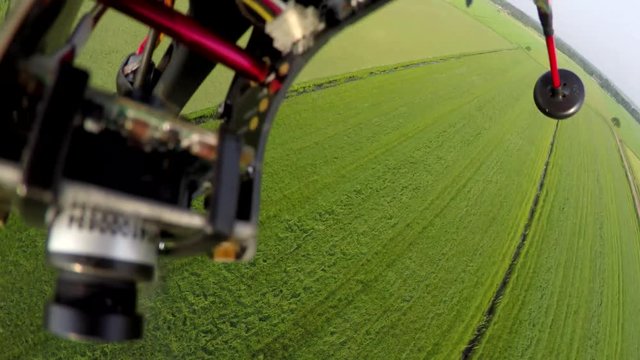 First person view onboard drone having technical failures crashing into ground fast and hard crash drone accident crash into grass farm landscape quadcopter electronics and extra camera showing 4k