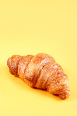Tasty croissant with chocolate and jam on yellow background