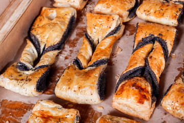 Sweet pastry, Puff pastry with poppy filling on shelf in Bakery shop. Pastries and bread in a bakery